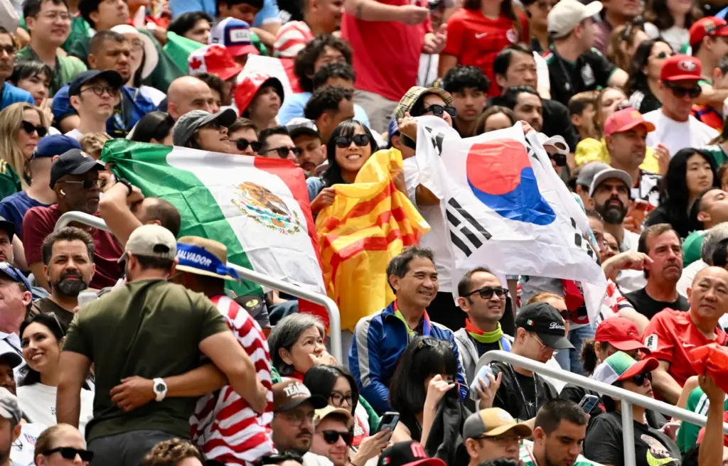 Fans hold up flags from other countries in the second...