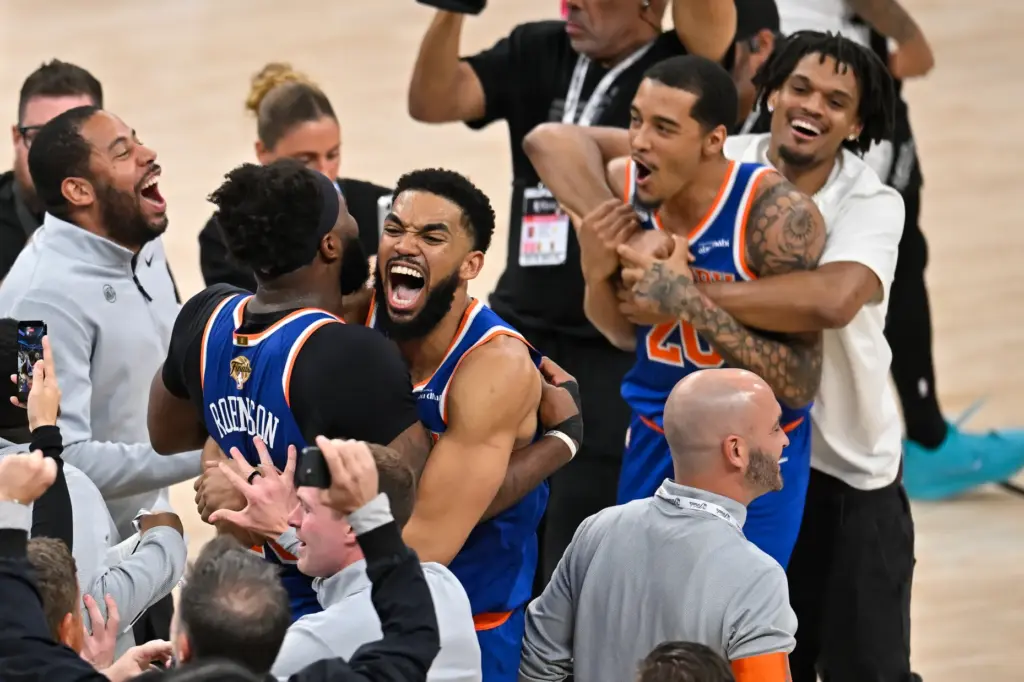 New York Knicks center Karl-Anthony Towns, right, hugs forward Og...