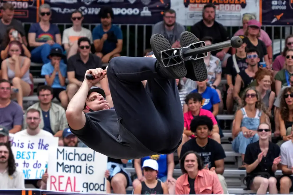 Extreme pogo athlete Michael Mena does a back flip during...