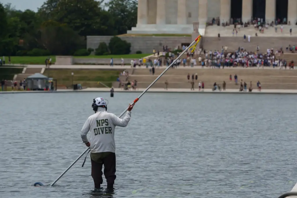 A National Park Service employee works to clean the Lincoln...