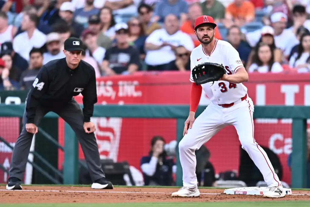 Angels first baseman Trey Mancini, right, gets in position to...