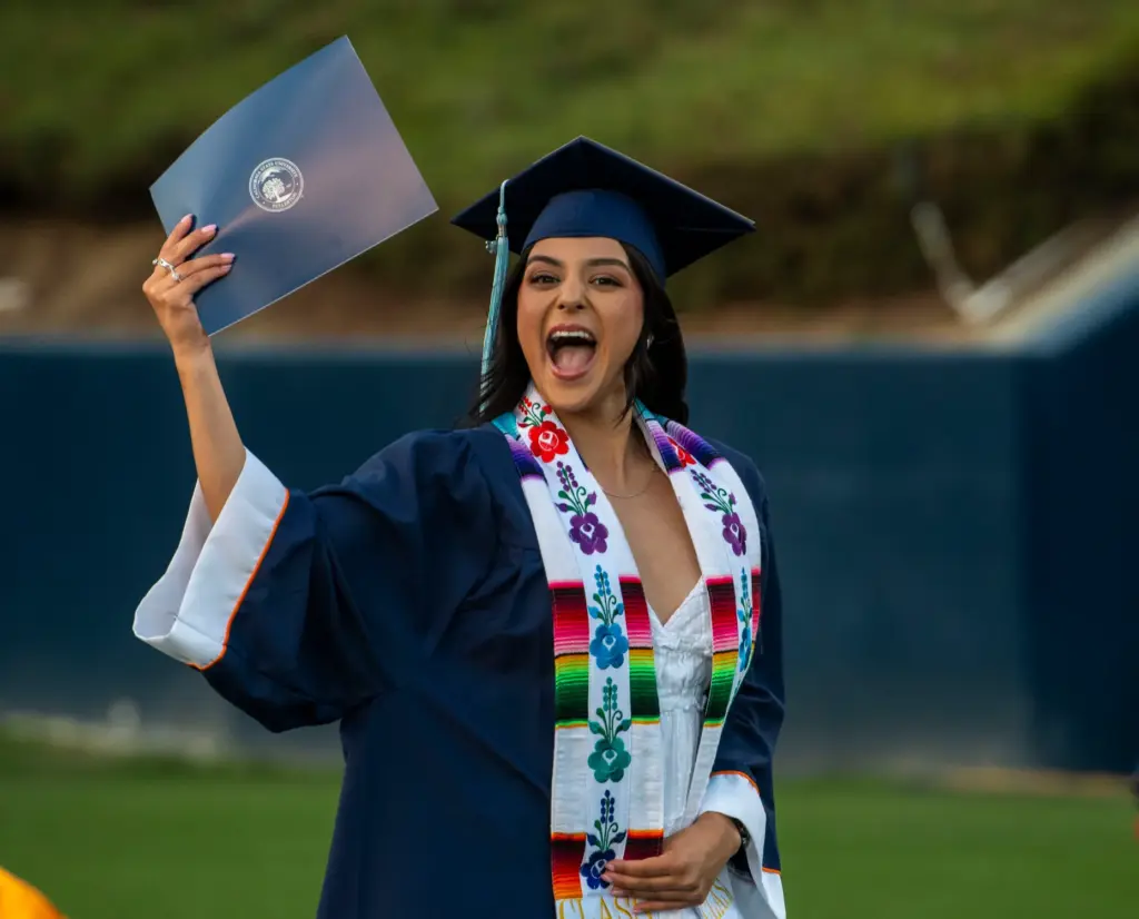 Valerie Becerra celebrates her diploma during CSUF College of Education...