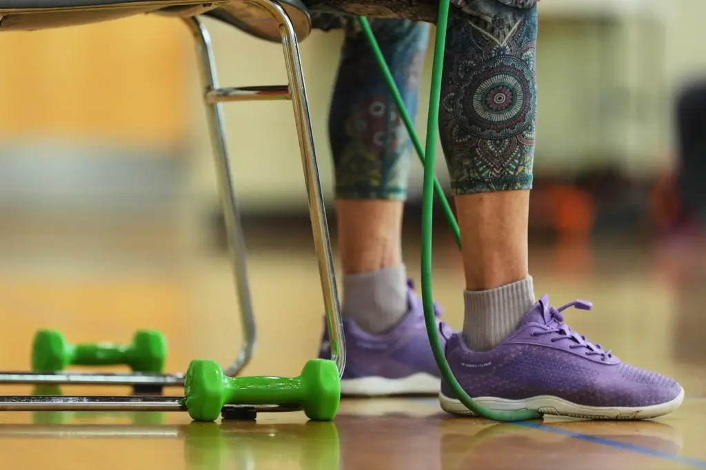 A participant uses an exercise band during a class for older adults.