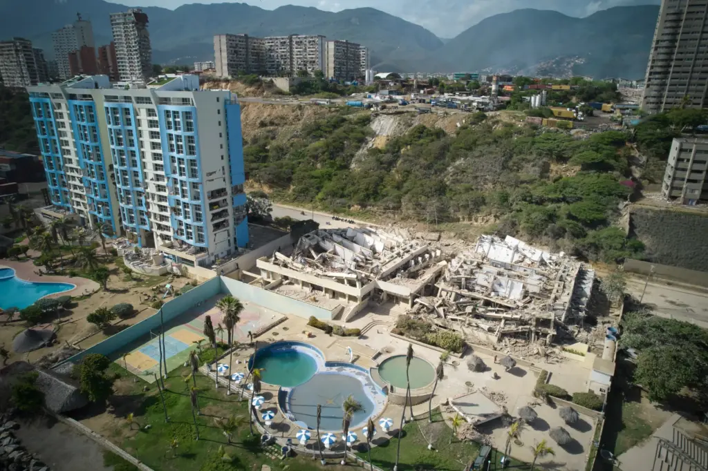 Collapsed buildings stand a day after earthquakes struck La Guaira,...