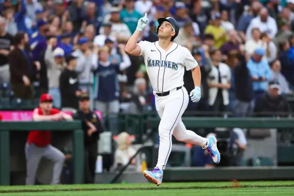 The Seattle Mariners’ Dominic Canzone gestures as he runs the...
