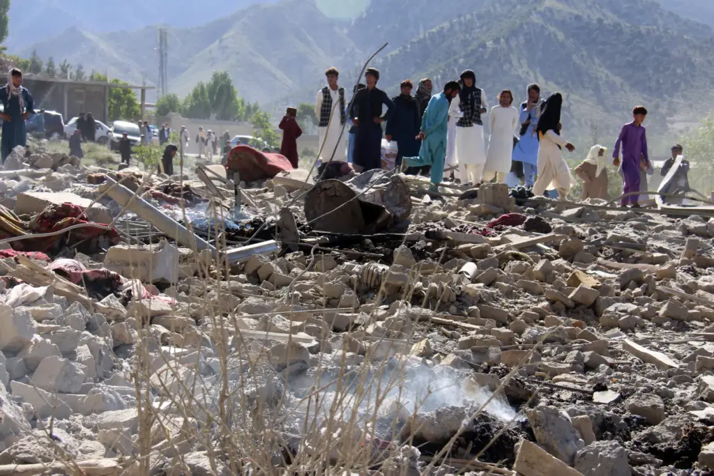Residents walk through the rubble in Mandokhail, Afghanistan.