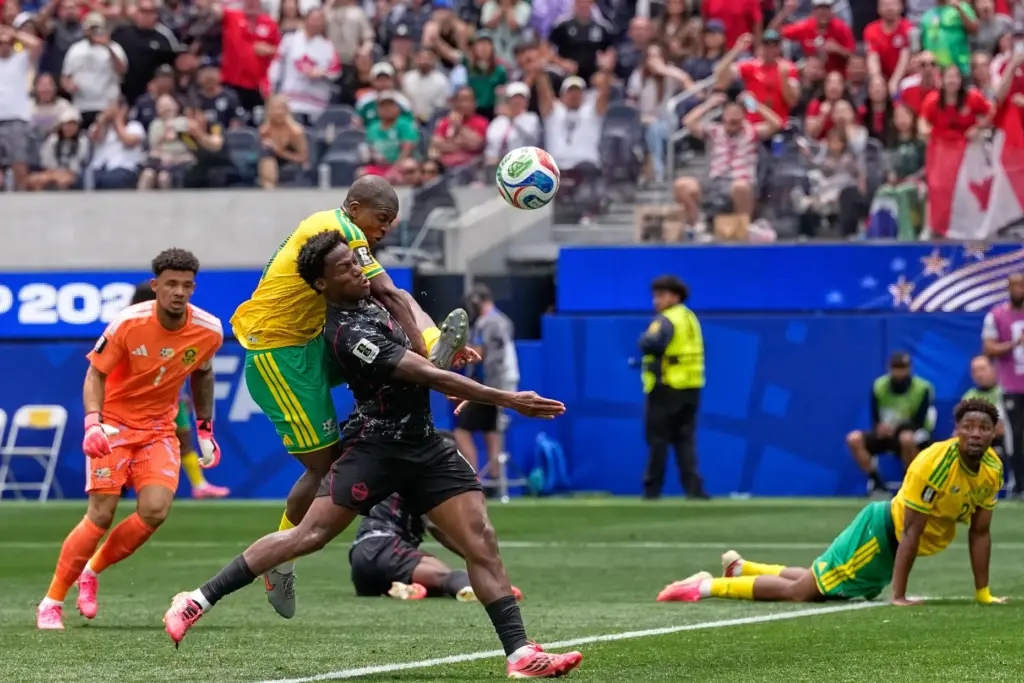 Canada’s Jonathan David, front, and South Africa’s Mbekezeli Mbokazi battle...