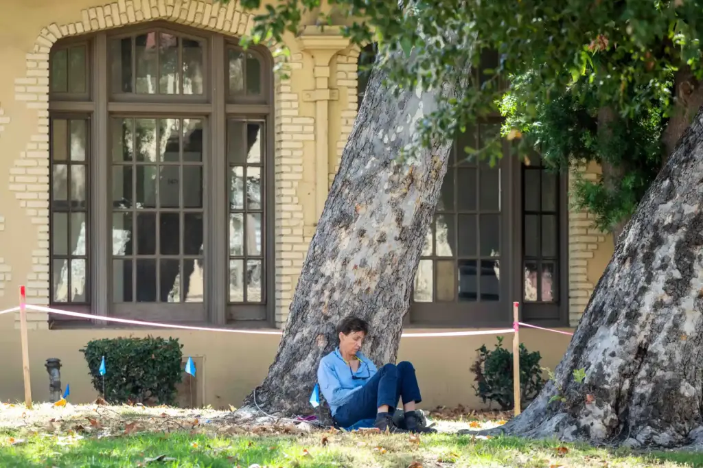 Arborist Sabine Hoppner, of Altadena Green, keeps watch on two...