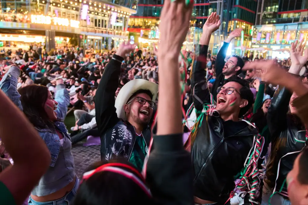 Fans react as they watch a broadcast of the World...