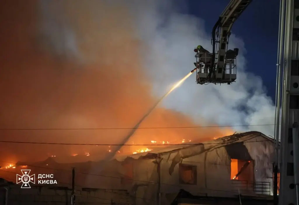 Emergency services personnel work to extinguish a fire following a Russian air attack.
