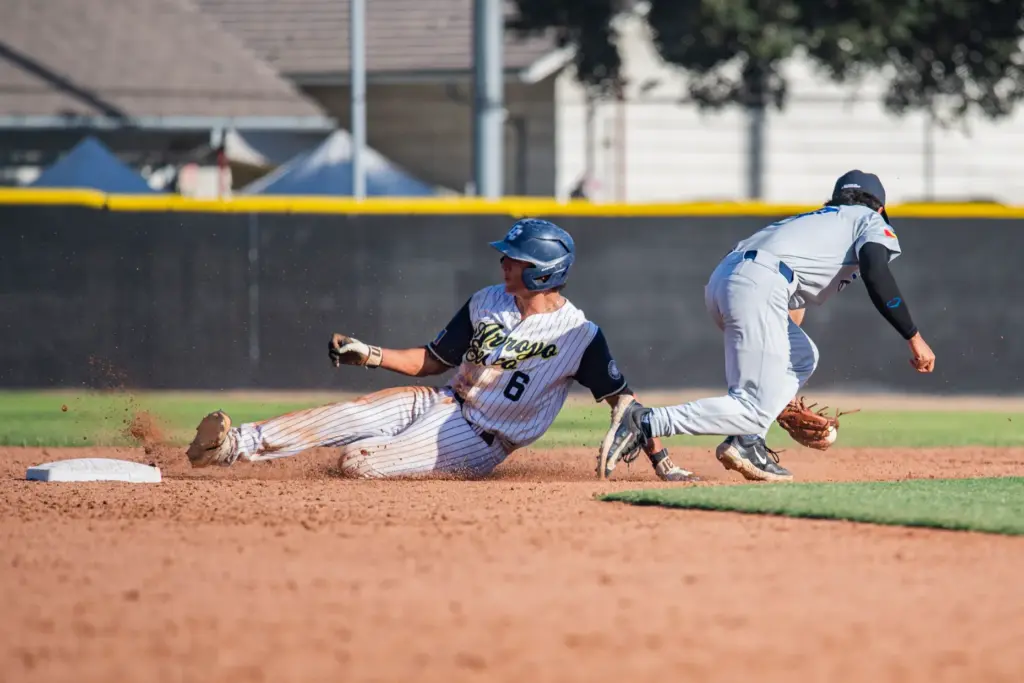 Arroyo Seco Saints catcher Dylan Garcia steals second against the...