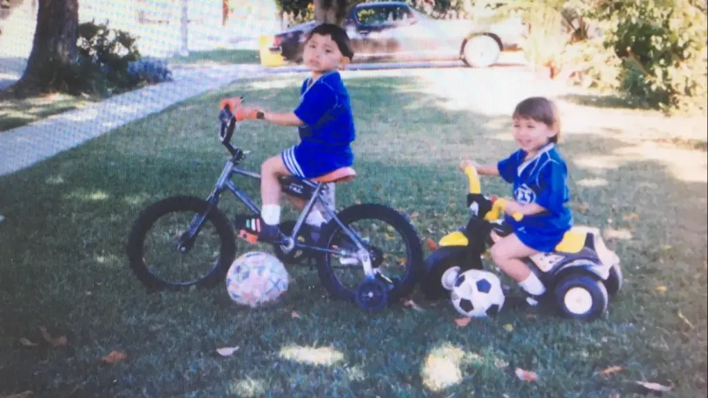 Cristian Roldan, left, and Alex Roldan, right, ride bikes during...