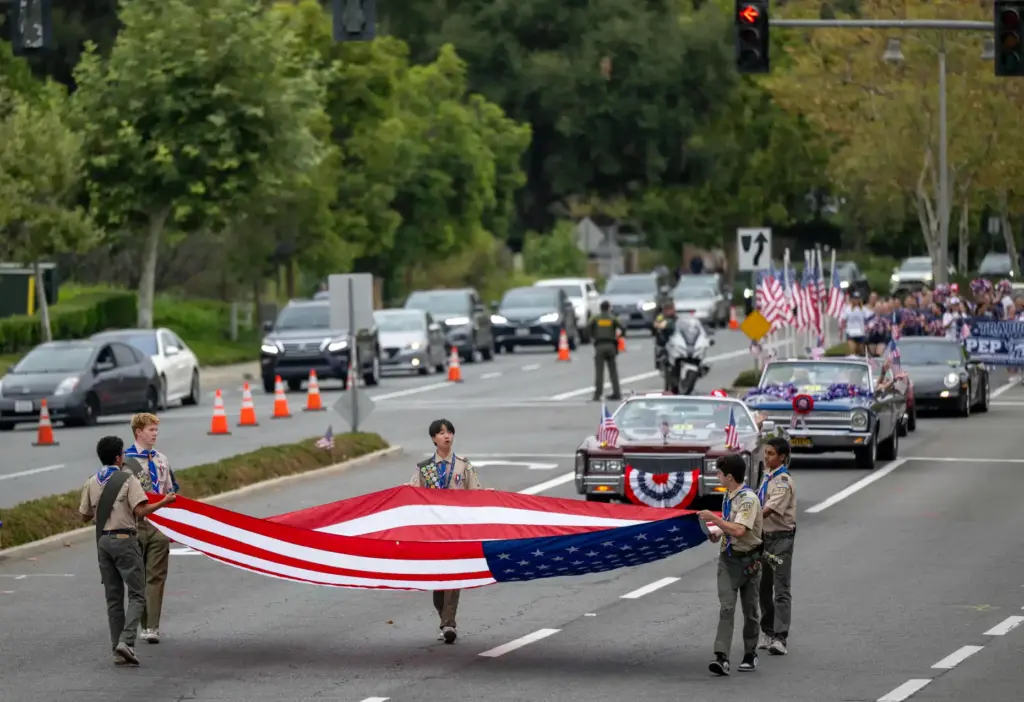 Members of Boy Scouts of America Troop 2020 carry a...