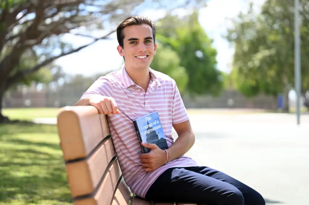 Recent high school graduate Kevin McGowan with his book, âCourage...