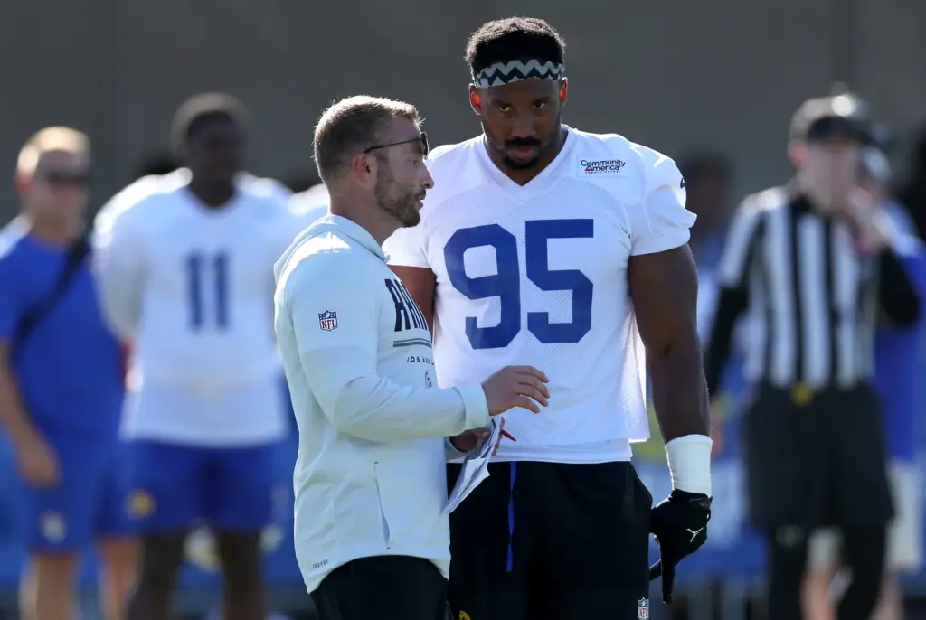 Rams head coach Sean McVay talks with defensive lineman Myles...