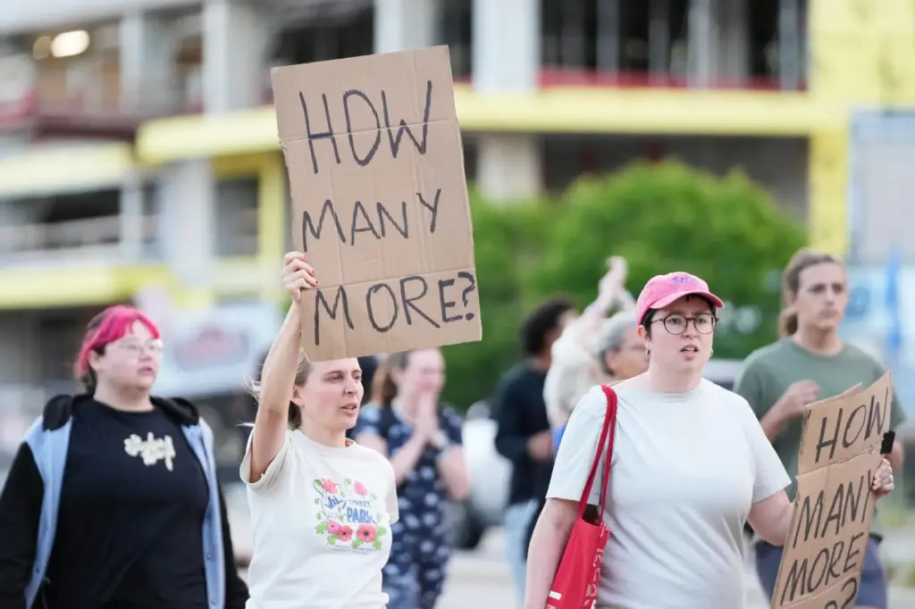 Protesters march after a Madison police officer shot and killed...