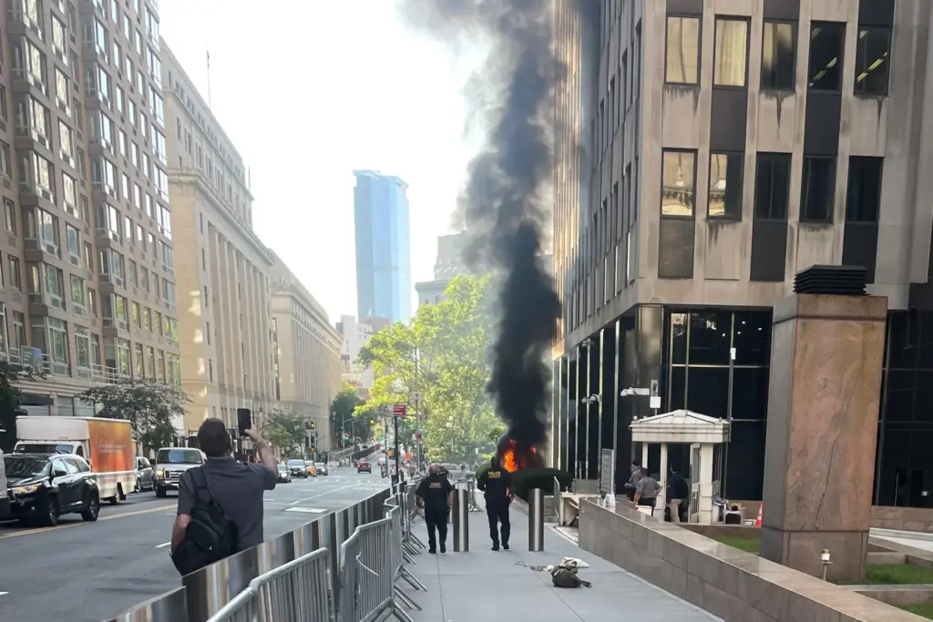 This photo provided by Robert Sullivan shows black smoke and...