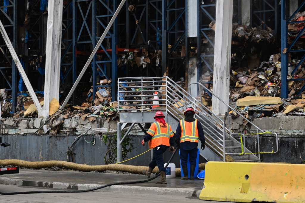 Work crews at the burn site. Residents and community organizations...
