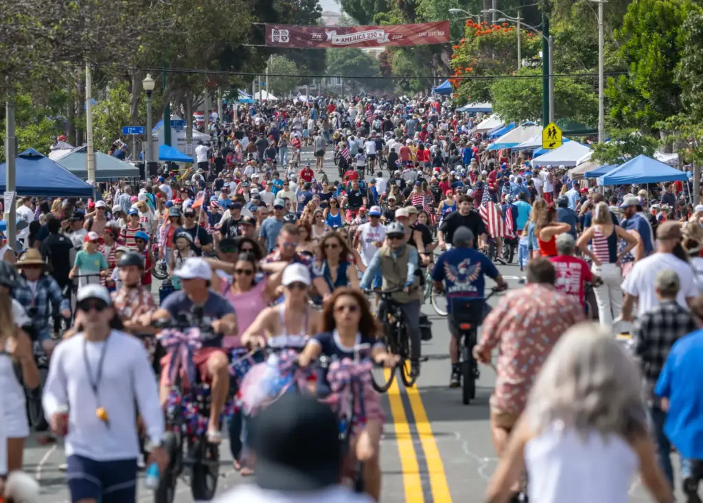 Thousands walk and ride bikes along the parade route on...