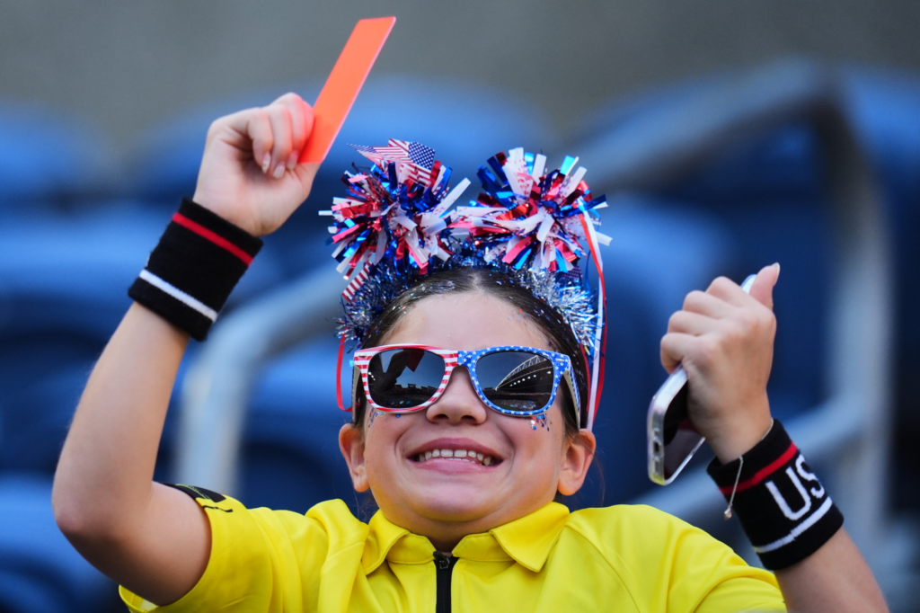A fan of the United States holds a red card...