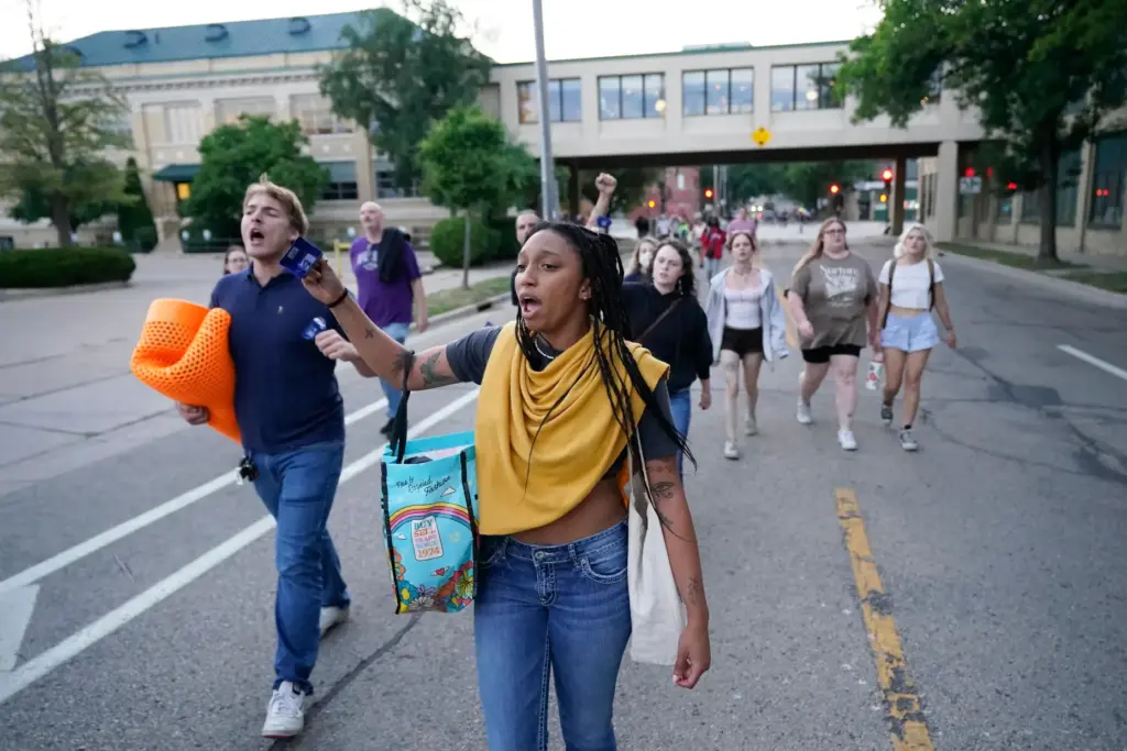 Protesters march after a Madison police officer shot and killed a man.