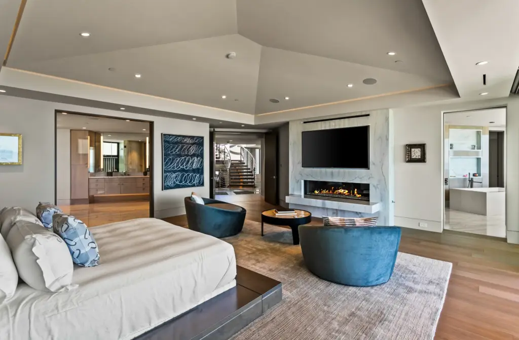 A floor-to-ceiling marbled fireplace serves as the focal point of...