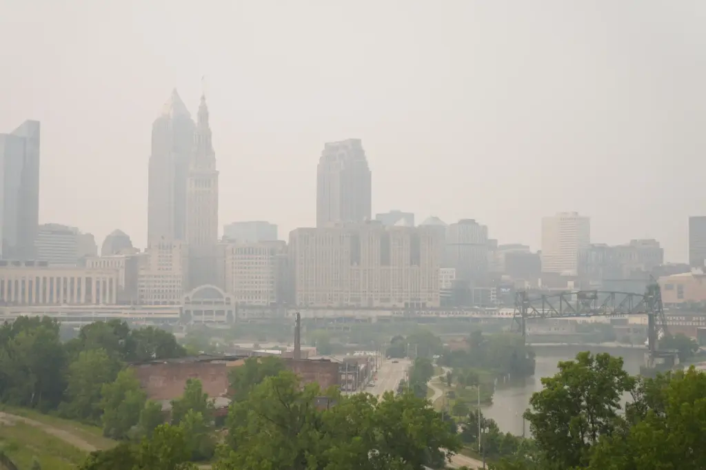Smoke from Canadian wildfires blankets downtown Cleveland, forcing the postponement...