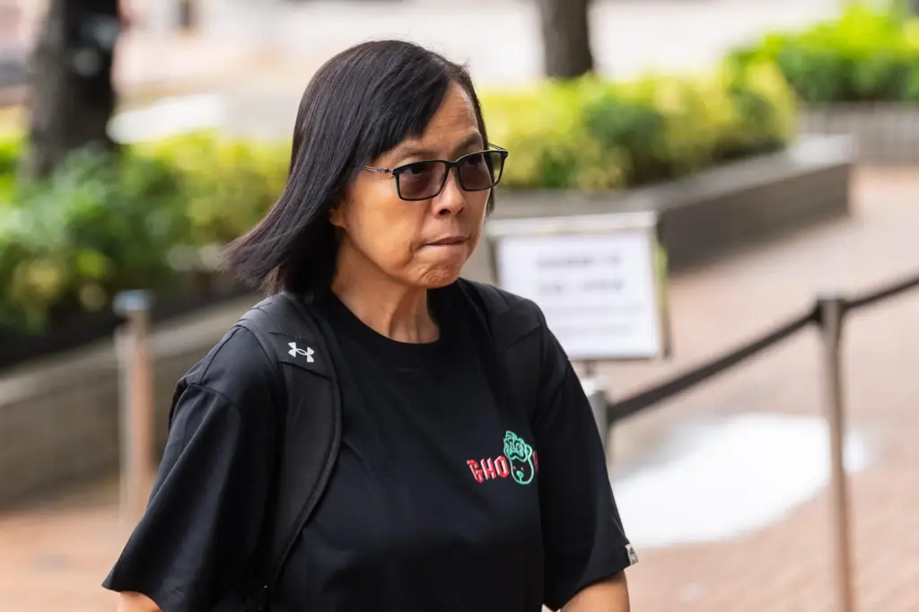 Betty Ho, resident of Wang Fuk Court, arrives for the...
