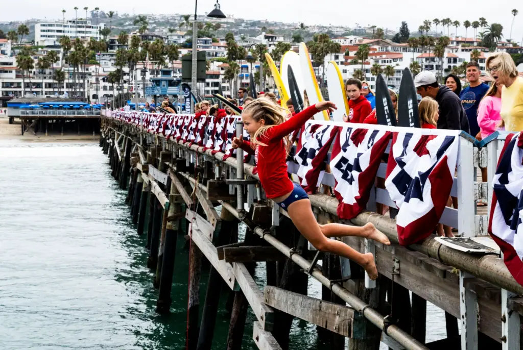 Jade Hales jumps off the San Clemente pier as part...