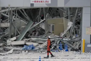 Rescuers search for survivors after a 7.1 quake kills 18 in southwestern Japan
