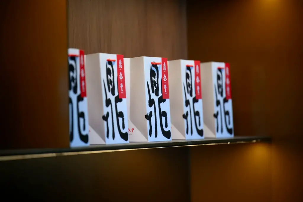 Stylized bags adorn shelves behind the reception area at Din...