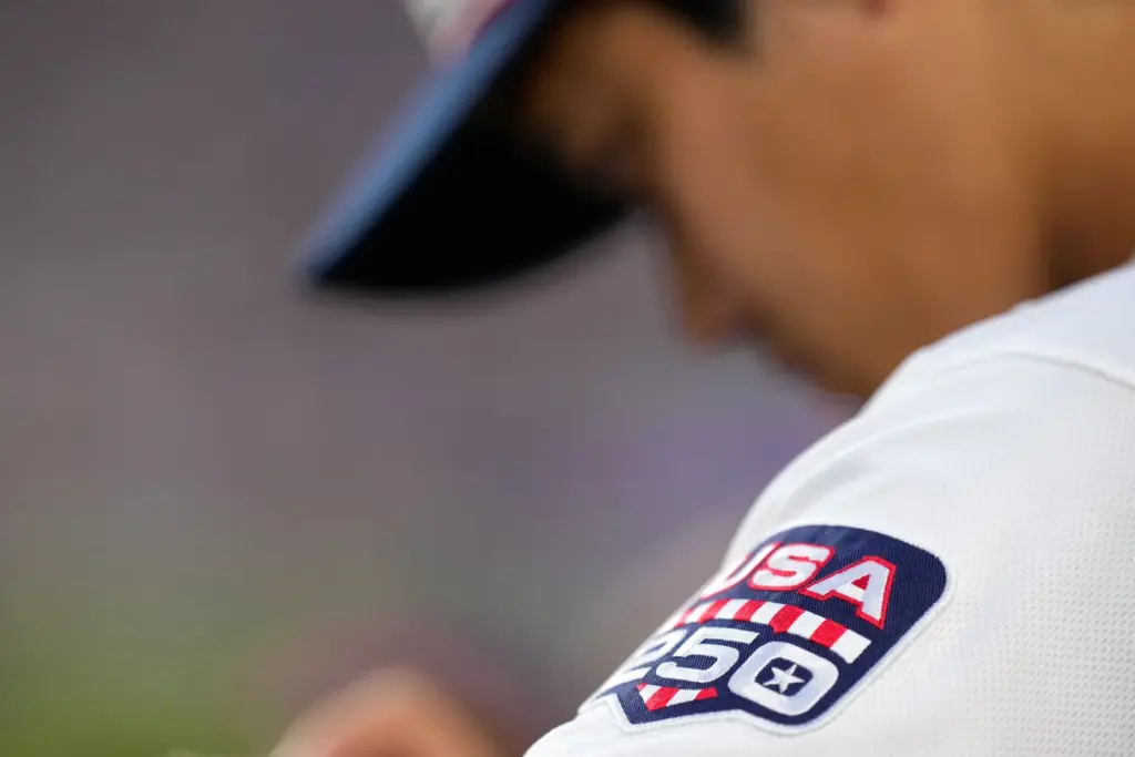 Dodgers’ Shohei Ohtani is seen in the dugout with a...