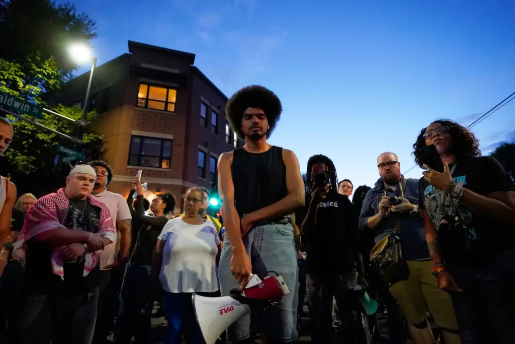 Attendees gather at a candlelight vigil where a Madison police officer shot and killed a man.