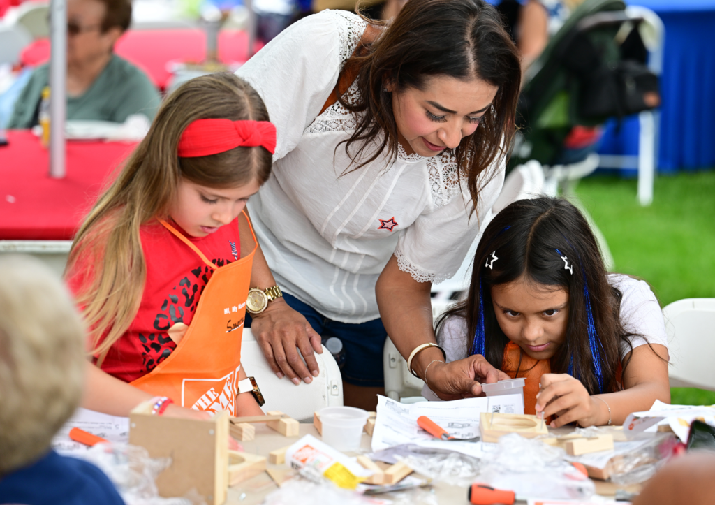 Savannah Aronsen works on a project while Yvette Barajas helps...