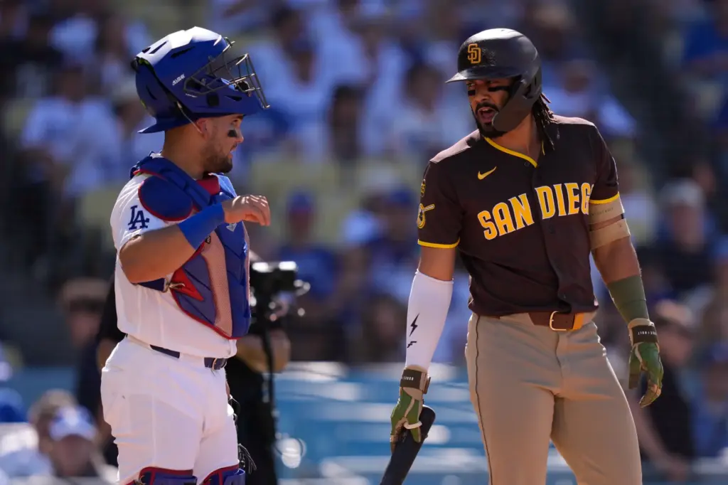 Dodgers catcher Eliezer Alfonzo, left, and San Diego Padres’ Fernando...