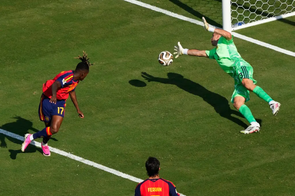 Argentina goalkeeper Emiliano Martinez stops a shot on goal by...