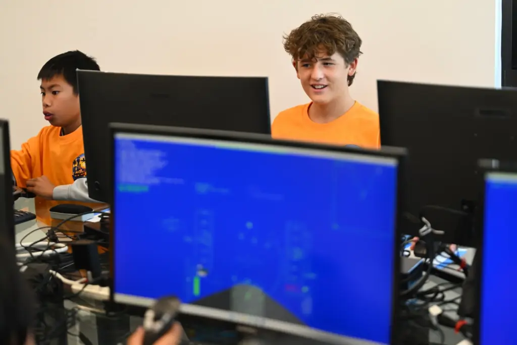 Camper Blake Preston flies a flight simulator during Aviation Summer...