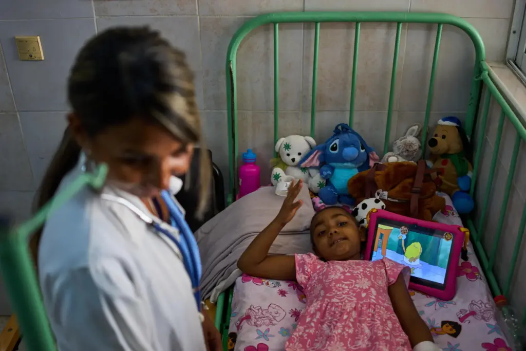 Karolina Silva Matis, a 6-year-old oncology patient, is examined by...