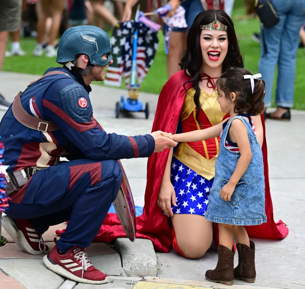 Sol Tovar,3, shakes hands with Captain America and Wonder Woman...