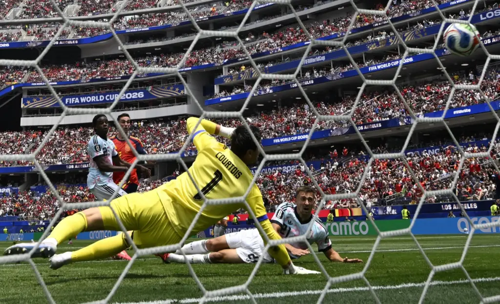 Spain midfielder Fabian Ruiz (8) scores past Belgium goalkeeper Thibaut...