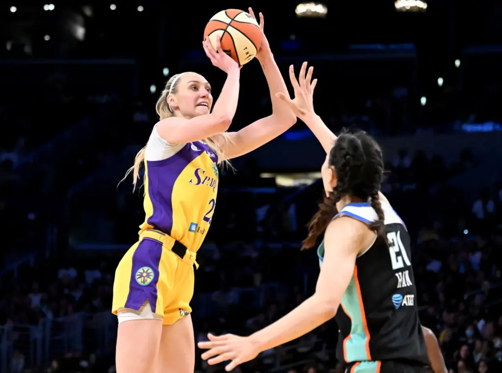 Sparks forward Cameron Brink, left, takes a shot as New...