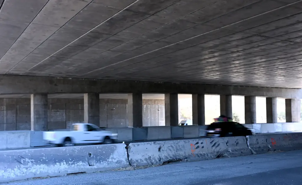 Traffic moves under the Wallis Annenberg Wildlife Crossing over the...