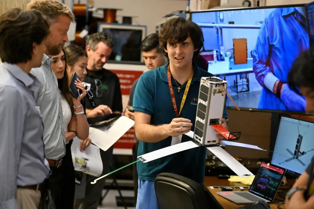 Brian Burke shows off the student-developed Maveric satellite at USC’s...