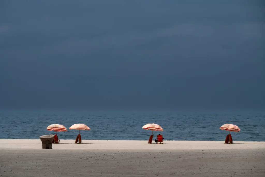 The sun begins to break through morning fog along the...