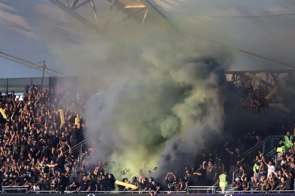 LAFC supporters light flares in the stands during the first...