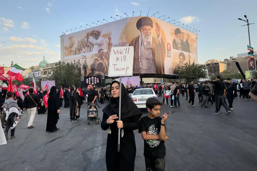 A woman holds a sign reading 