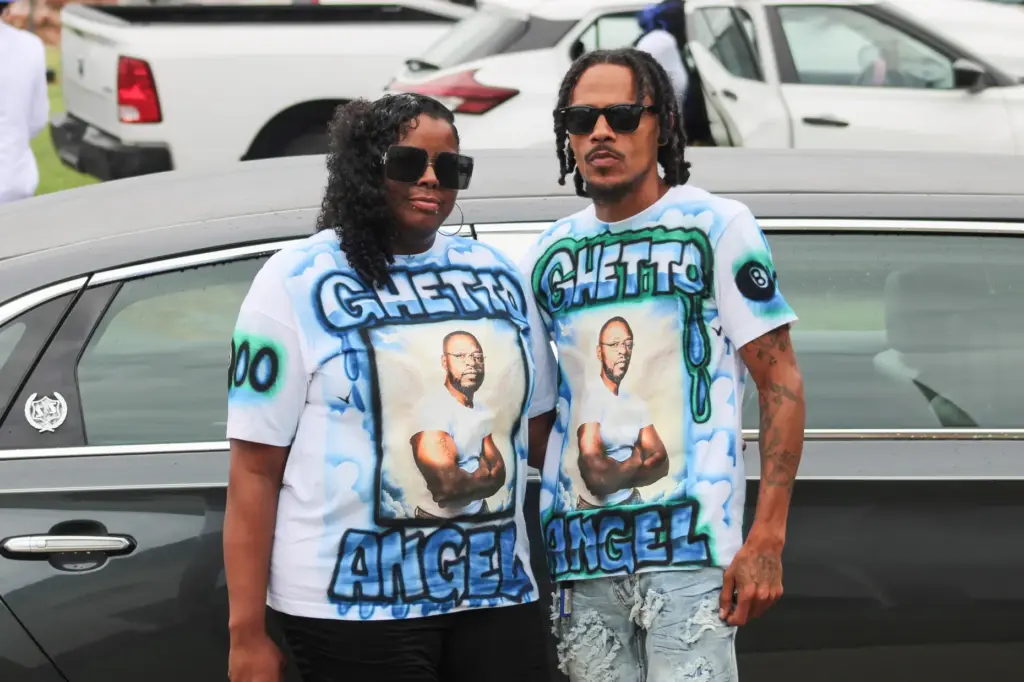 Lloyd Gilmore's friends, Tawanna and Willie Wilson, wore custom T-shirts to his funeral