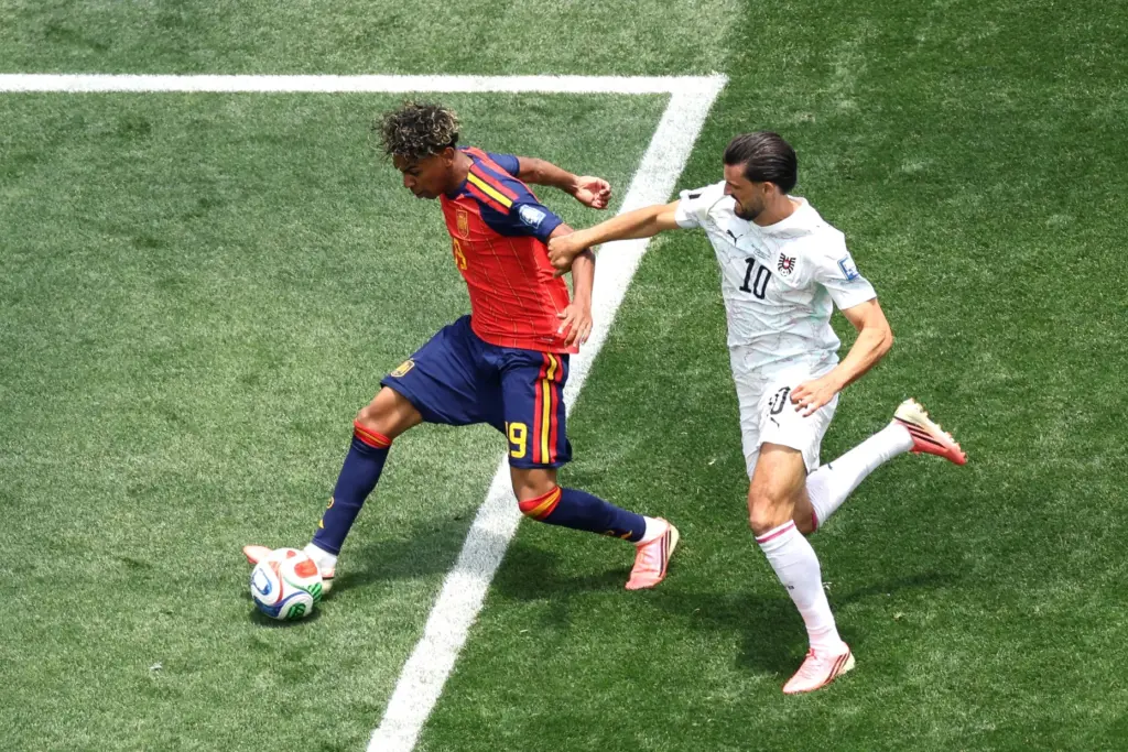 Spain forward Lamine Yamal (19) controls the ball as he...