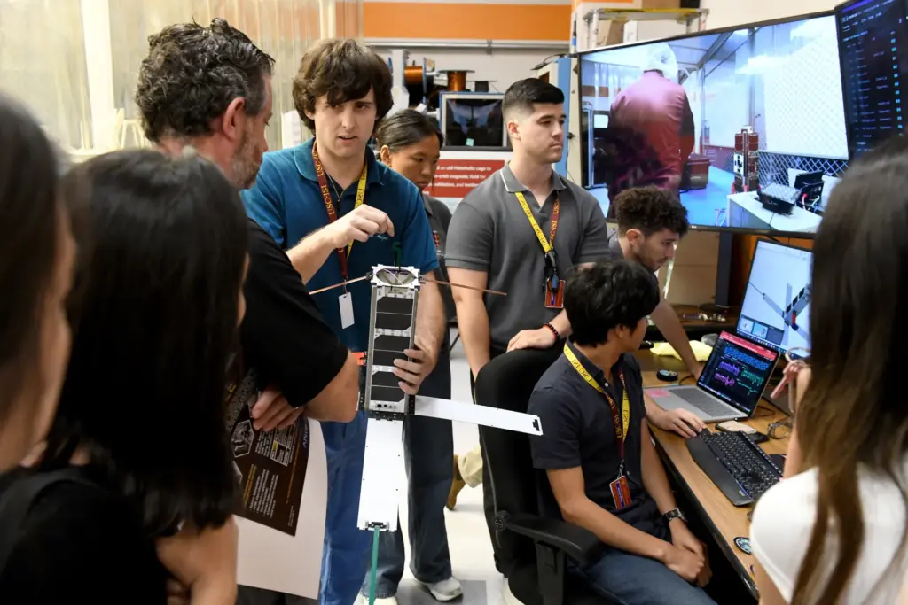 Brian Burke shows off the student-developed Maveric satellite at USC’s...