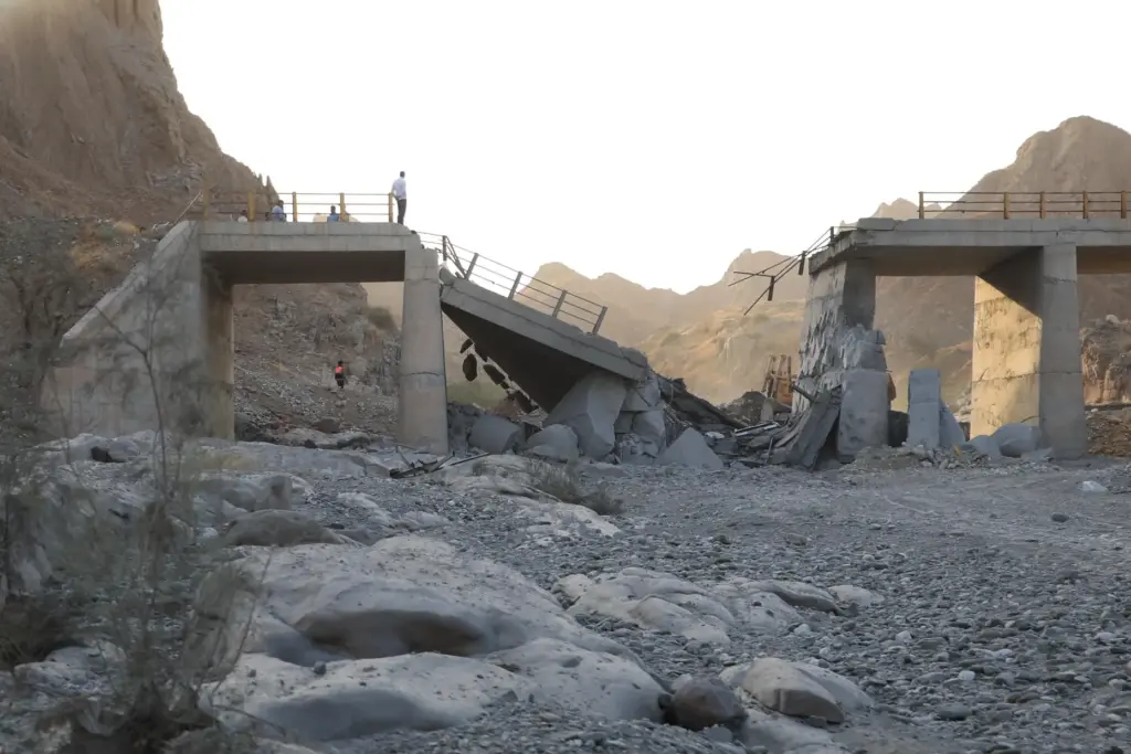 People stand on a bridge destroyed after a strike in Hormozgan province, southern Iran.